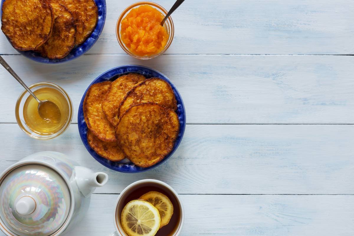 A cluttered kitchen counter with scattered ingredients and an unfinished recipe book