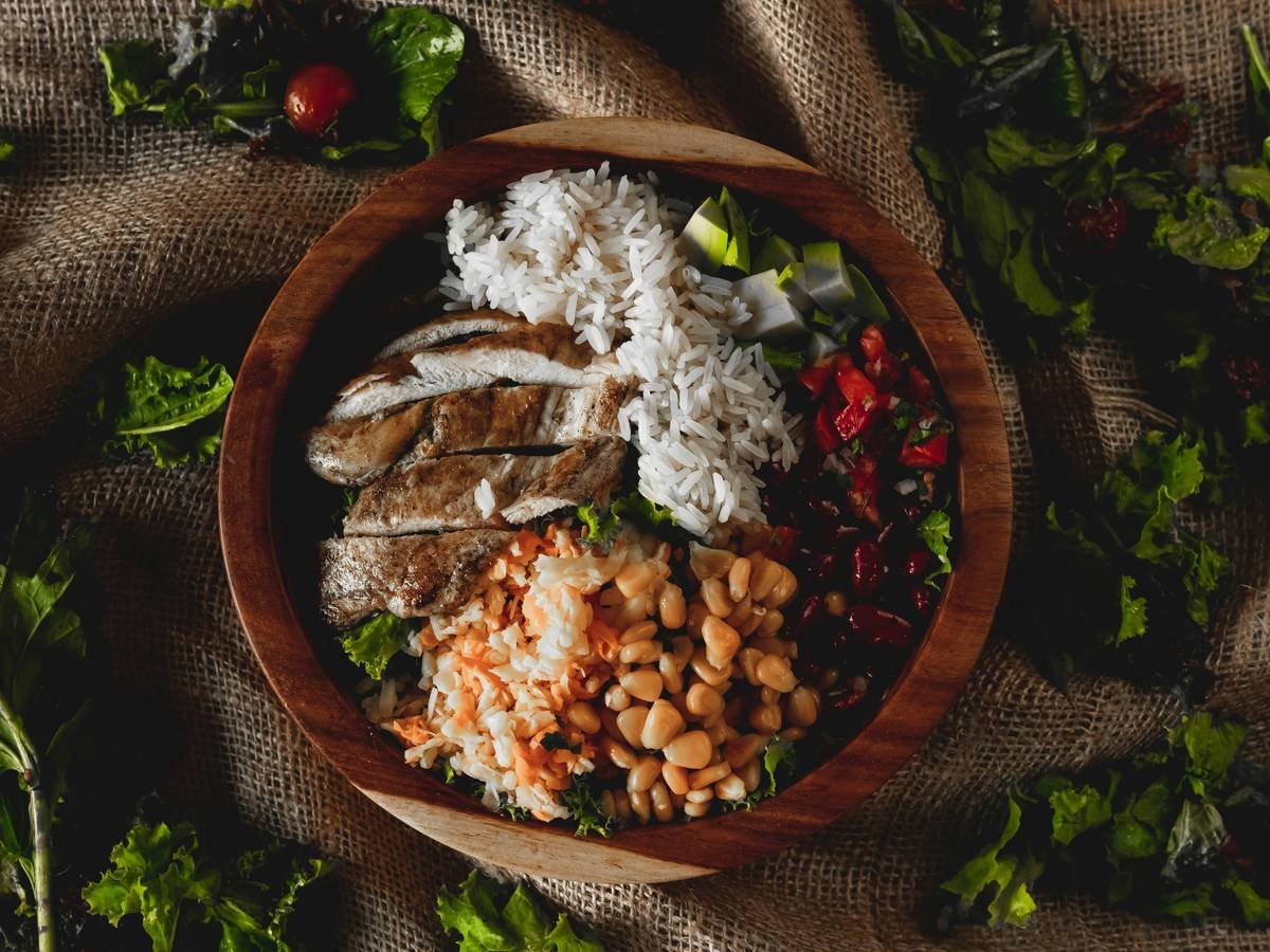 A plate of balanced meal prepared by BistroMD featuring grilled salmon, quinoa, and steamed vegetables