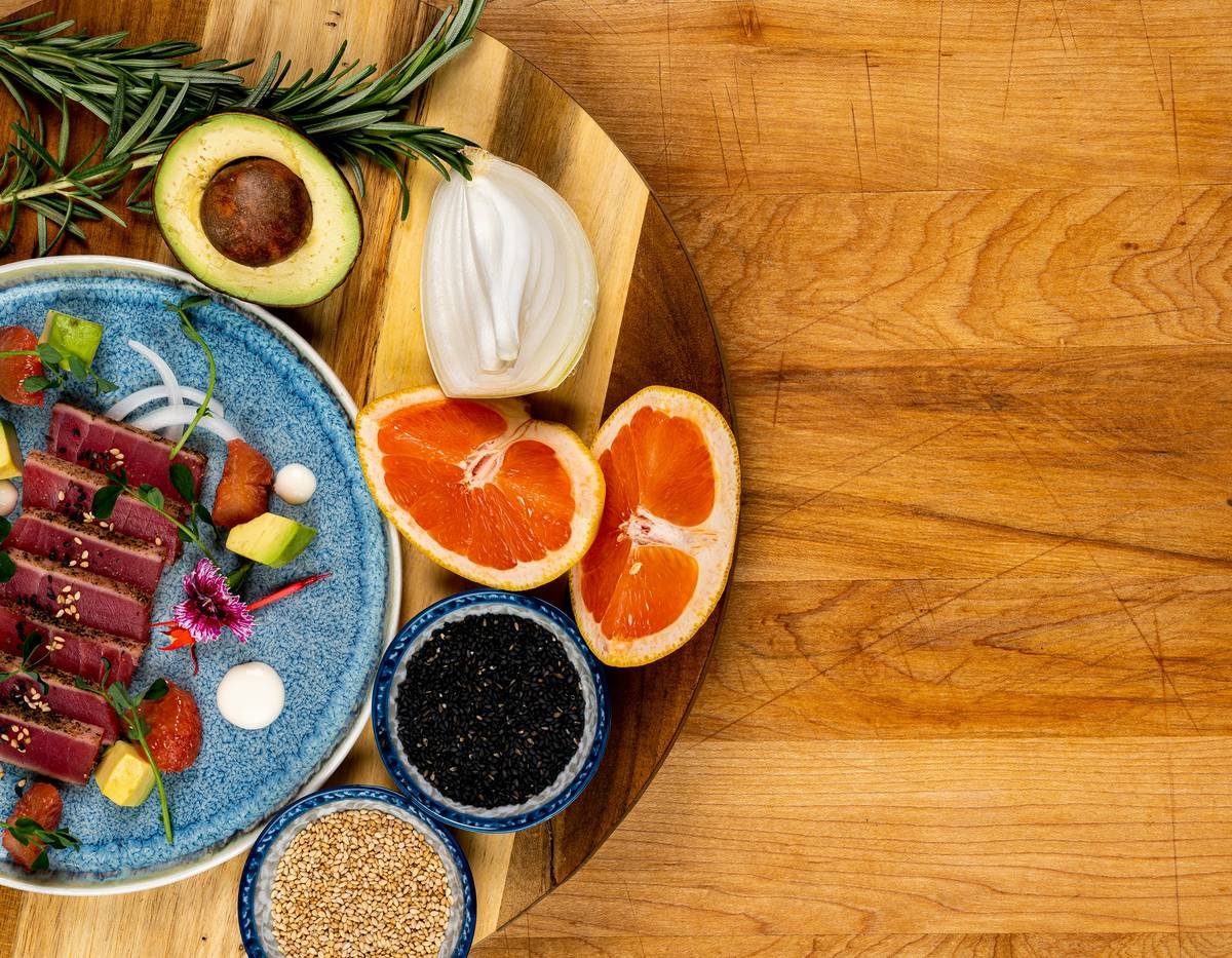 a wooden table topped with a plate of food